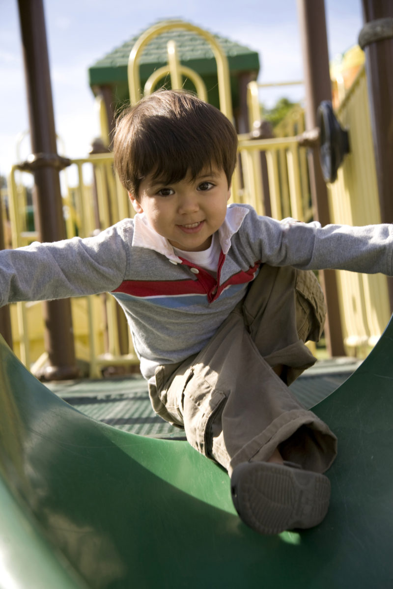 Smiling child on playground equipment