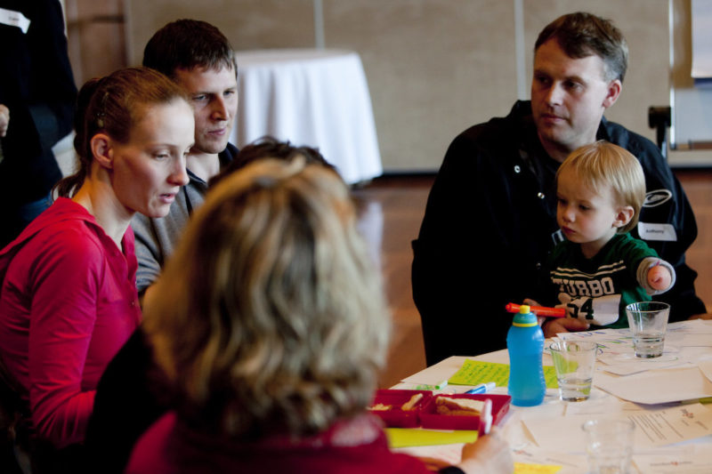 Four people in discussion while sitting around a table