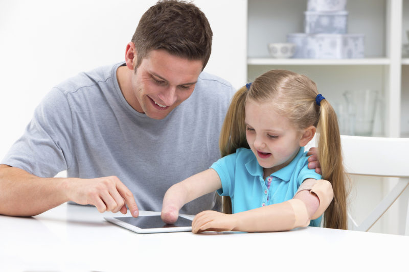 Adult and child using an iPad