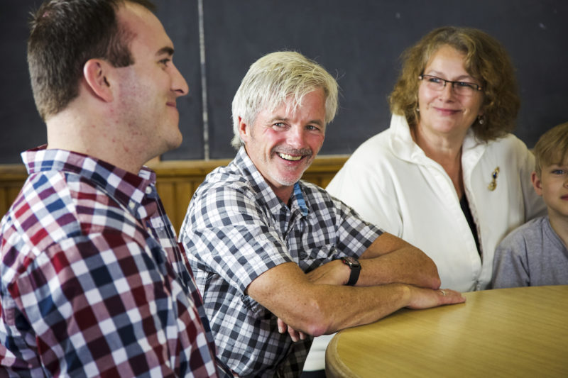 Adults sitting at a round table having a conversation