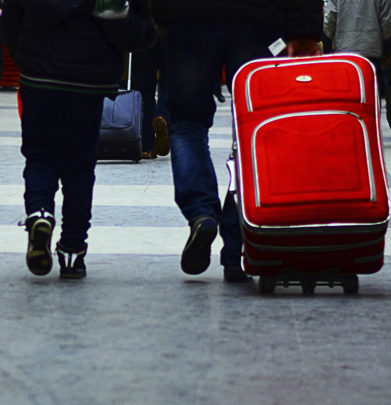 People with suitcases walking in an airport