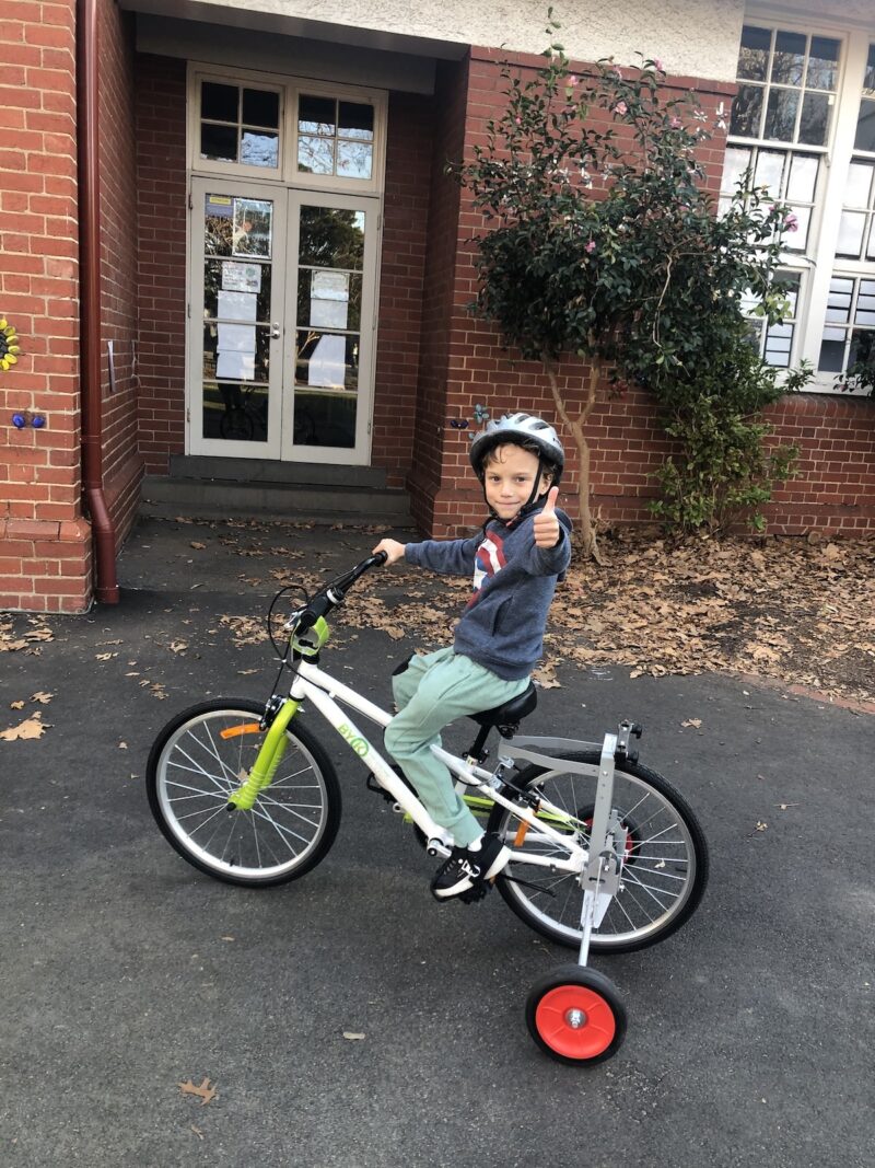 Seb riding his bicycle giving thumbs up